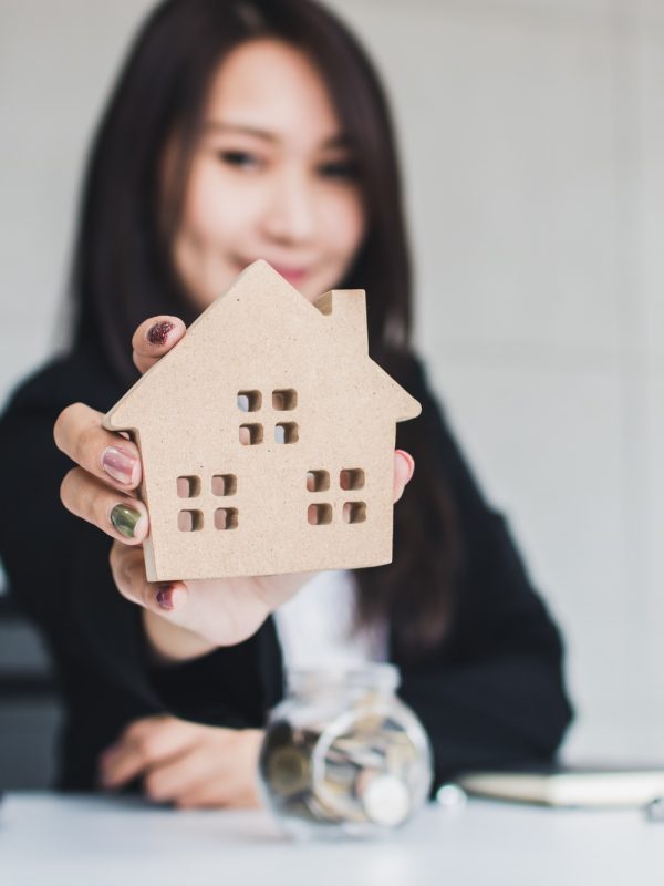 Business woman, Bank agency holding house model and give proposal, housing loan real estate concept Business woman, Bank agency holding house model and give proposal, housing loan real estate concept