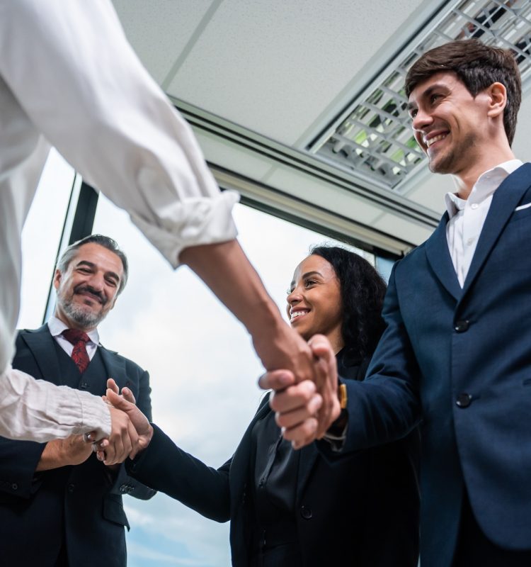 Caucasian businessman making a handshake together while stand in office. Caucasian businessman making a handshake together while stand in office.